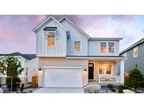 Charming two-story home with a brick facade, white siding, and a covered porch, creating a welcoming curb appeal at 3412 N Buchanan Way, Aurora, CO 80019