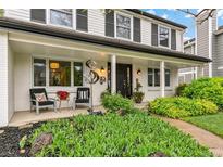 Inviting front porch with charming decor and manicured landscaping, creating a warm welcome at 6712 S Leyden Ct, Centennial, CO 80112