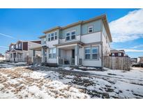 Charming two-story home with light blue and grey siding, complemented by large windows and a welcoming porch at 14106 Red Cosmos St, Parker, CO 80134