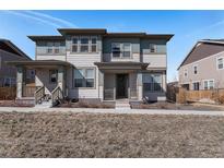 Charming two-story home with a covered porch and well-maintained lawn at 14106 Red Cosmos St, Parker, CO 80134