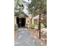 Inviting condo exterior featuring stone accents and well-maintained landscaping at 8338 S Independence Cir # 104, Littleton, CO 80128