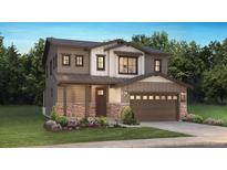 Charming two-story home featuring a stone-accented facade, attached two-car garage, and a well-manicured lawn at 8893 Springsong Ln, Littleton, CO 80125