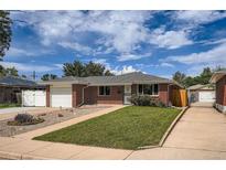 Charming brick home featuring a well-manicured front lawn, attached garage, and inviting curb appeal at 1785 S Zuni St, Denver, CO 80223