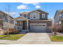 Charming two-story home with a well-manicured lawn and attached two car garage at 24784 E Tennessee Pl, Aurora, CO 80018