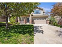 Charming two-story home with a two-car garage and a well-manicured lawn and front porch at 3928 Miners Candle Dr, Castle Rock, CO 80109