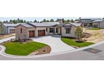 Beautiful home with stone accents, a large driveway, and manicured landscaping at 8015 Parnassus Pl, Castle Rock, CO 80108
