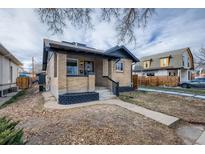 Charming brick home featuring a cozy front porch and well-maintained landscaping at 4045 Shoshone St, Denver, CO 80211