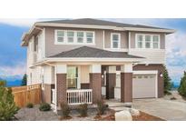 Beautiful two-story home featuring a brick facade, covered porch, and an attached garage at 20724 E 57Th Ave, Aurora, CO 80019