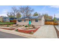 Charming home features a solar roof, a colorful front door, and low-maintenance landscaping at 741 Cortez St, Denver, CO 80221