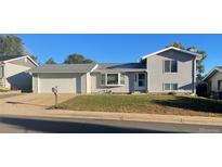 Charming gray two-story home with a well-maintained front yard and an attached two-car garage at 3097 W 134Th Way, Broomfield, CO 80020