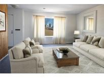 Bright living room featuring neutral decor, large windows, and comfortable seating at 8746 Mariposa St, Thornton, CO 80260