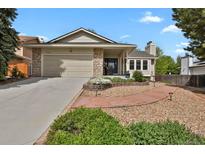 Charming single-Gathering home with stone accents, a two-car garage, and a beautifully landscaped front yard at 7466 E Long Cir, Centennial, CO 80112