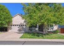 Charming brick home featuring a lush front lawn and a well-maintained two-car garage at 10156 Nottingham Dr, Parker, CO 80134