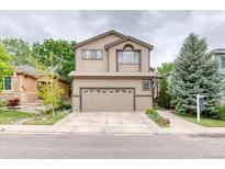 Charming two-story home featuring a well-manicured front yard and an attached two-car garage at 10191 Sagecrest St, Highlands Ranch, CO 80126