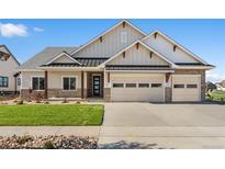 Charming single-Gathering home with two-car garage, stone accents, and a well-manicured front lawn at 1402 Burt Ave, Berthoud, CO 80513