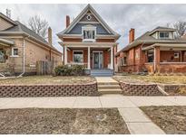 Charming two-story brick home with inviting front porch and manicured lawn at 3833 Umatilla St, Denver, CO 80211