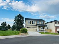 Charming two-story home featuring a lush lawn, two car garage, and traditional architectural style at 16893 Trail View Cir, Parker, CO 80134