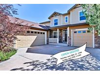 Inviting home featuring a multi-car garage, stone accents, and an open house banner in the driveway at 10646 Amesbury Way, Highlands Ranch, CO 80126
