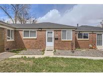 Charming brick home with well-maintained lawn, sidewalk, and front door under a partly cloudy sky at 1537 Xenia St, Denver, CO 80220