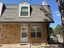 Charming brick exterior of a two-story home with a bench in the front yard and a welcoming front door at 1537 S Owens St # 31, Denver, CO 80232
