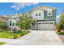 Charming two-story home featuring a well-manicured lawn and inviting curb appeal on a beautiful sunny day at 800 Meadowlark Dr, Erie, CO 80516
