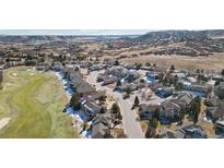 Wonderful aerial view of the home and surrounding neighborhood with golf course and mountain views at 2059 June Ct, Castle Rock, CO 80104