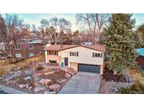 Inviting two-story home with a well-maintained lawn and a two-car garage at 6742 Flower St, Arvada, CO 80004