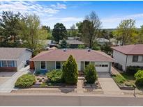 Charming home featuring well-maintained landscaping, a one-car garage, and a beautiful garden at 1650 Bedivere Cir, Lafayette, CO 80026