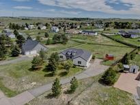 Lovely aerial view of the home, detached garage, surrounding property and neighborhood at 34544 Columbine W Trl, Elizabeth, CO 80107