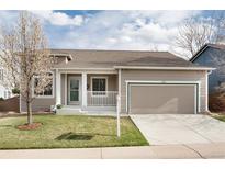Charming home featuring a two-car garage, well-maintained lawn, and neutral-tone siding at 9640 Sydney Ln, Highlands Ranch, CO 80130