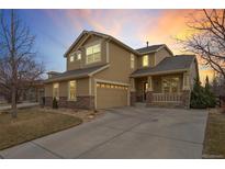 Inviting two-story home featuring a covered front porch and an attached two-car garage at 1017 Mircos St, Erie, CO 80516