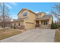 Charming two-story home with stone accents, covered porch, and attached two car garage at 1017 Mircos St, Erie, CO 80516