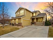 Lovely two-story home with stone accents, covered porch, and well-manicured landscaping at 1017 Mircos St, Erie, CO 80516
