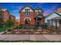 Charming brick home with a well-maintained front yard and inviting front porch at 2815 Curtis St, Denver, CO 80205