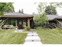 Charming single-story home with a dark facade, stone steps, and manicured landscaping at 130 S Eudora St, Denver, CO 80246