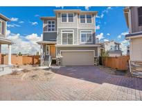 Inviting two-story home featuring a spacious two-car garage and charming exterior accents at 10124 Xanadu St, Commerce City, CO 80022