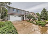 Charming two-story home with a well-maintained lawn, wide driveway, and two-car garage at 5120 Perth St, Denver, CO 80249