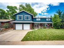 Charming two-story home with blue siding, brick accents, manicured lawn, and a welcoming front porch at 4645 W Temple Pl, Denver, CO 80236