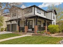 Charming two-story home with a covered front porch, landscaped lawn, and a two-car garage at 10938 Mcclellan Rd, Parker, CO 80134