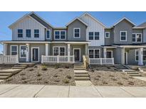 Charming townhome with covered porch, professional landscaping, and inviting curb appeal at 2002 S Haleyville Way, Aurora, CO 80018