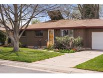 Charming brick home with mature landscaping, a well-kept lawn, and a quaint front entrance at 4182 W Quinn Pl, Denver, CO 80236