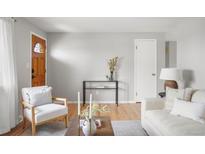 Inviting living room featuring hardwood floors, neutral walls, and stylish decor at 4182 W Quinn Pl, Denver, CO 80236