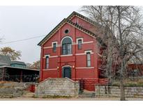 Red brick building with steps and a dark-colored door at 3233 Osage St # 2A, Denver, CO 80211