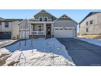 Two-story house with gray siding, white trim, and a covered porch at 968 Congress Pl, Elizabeth, CO 80107
