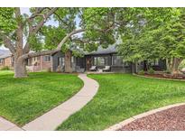 Charming home with a well-maintained lawn and a stone pathway leading to the front door at 900 Locust St, Denver, CO 80220