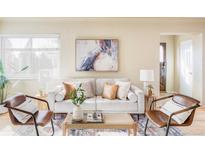 Cozy living room with neutral tones, stylish furnishings, and ample natural light at 4215 W Byron Pl, Denver, CO 80212