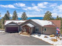 Charming home with mountain views, inviting entryway and large driveway at 28592 Hummingbird Hill Rd, Conifer, CO 80433