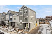 Modern two-story townhome featuring a stylish gray exterior and well-maintained landscaping at 1530 Terry St, Longmont, CO 80501