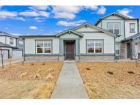 Charming home showcasing great curb appeal with stone accents and manicured landscaping at 152 Ambrose St, Erie, CO 80516