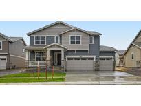 Charming two-story home with a three car garage and a beautifully landscaped front yard at 4588 Thistle Dr, Brighton, CO 80601